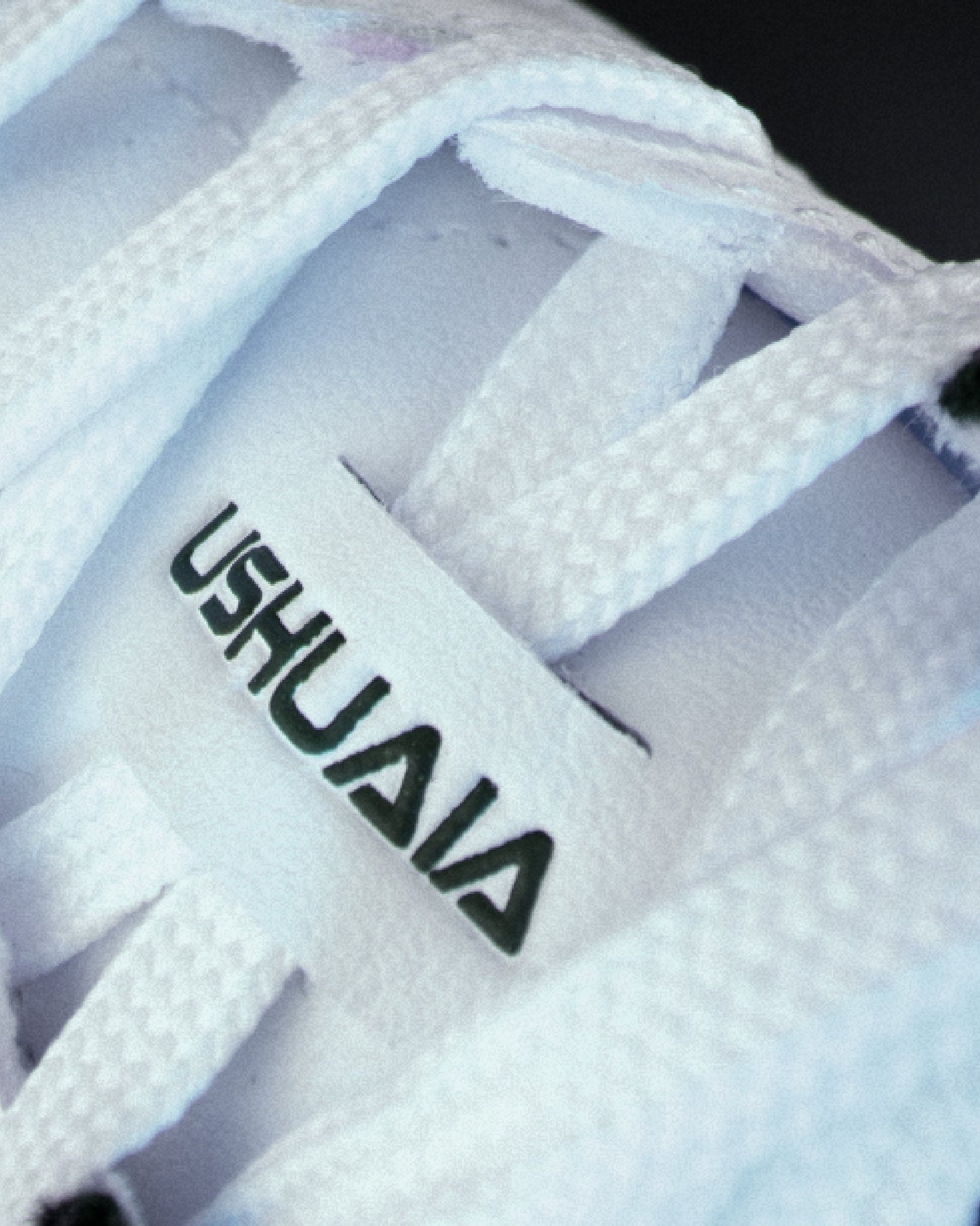 Detailed close-up of side logo on white Senda Ushuaia Pro 2.0 futsal shoe, showcasing breathable TPU upper and precise textured paneling for enhanced durability.