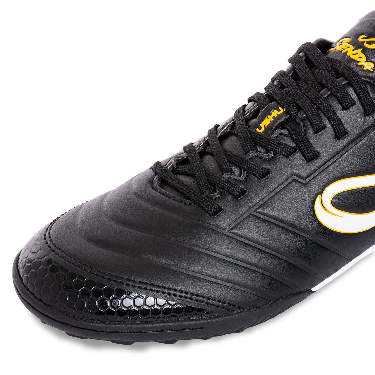 Closeup front angle of Senda Ushuaia Academy Turf Black featuring honeycomb textured toe and black synthetic upper.