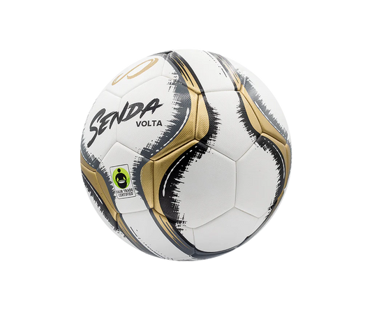 Angled side view of Senda Volta soccer ball showing textured gold panels, dynamic black graphic design, and Fair Trade Certified stamp.