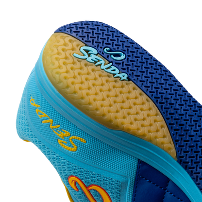 Close-up heel view of Blue Ushuaia Club 2.0 Futsal Shoes by Senda – Textured gum rubber outsole with Senda branding and heel grip pattern for stability, traction, and non-slip performance on indoor futsal courts.

