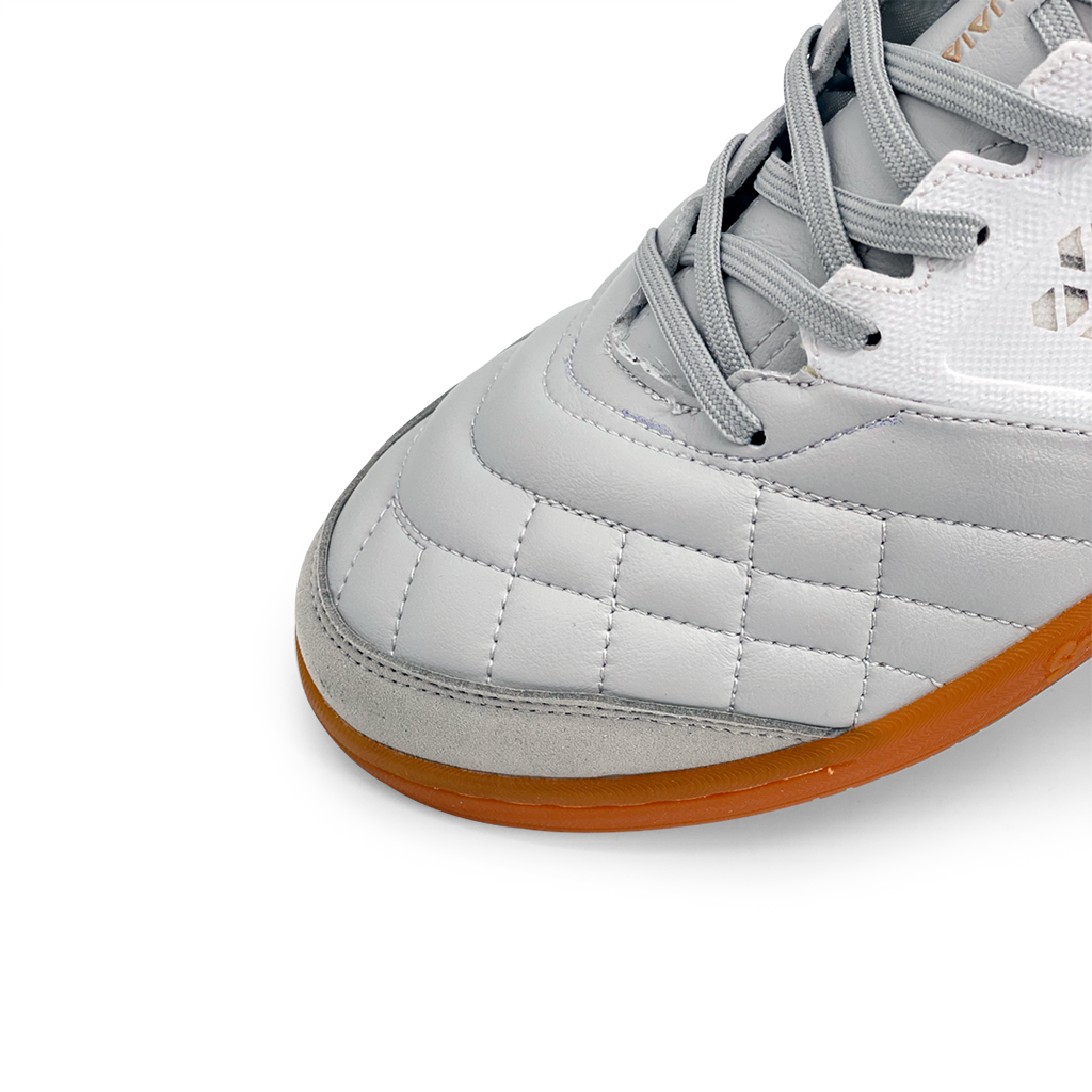 Close-up of Senda Ushuaia Pro 2.0 White Gold futsal shoe showing stitched toe panel, reinforced suede tip, and gum sole for optimal ball control.

