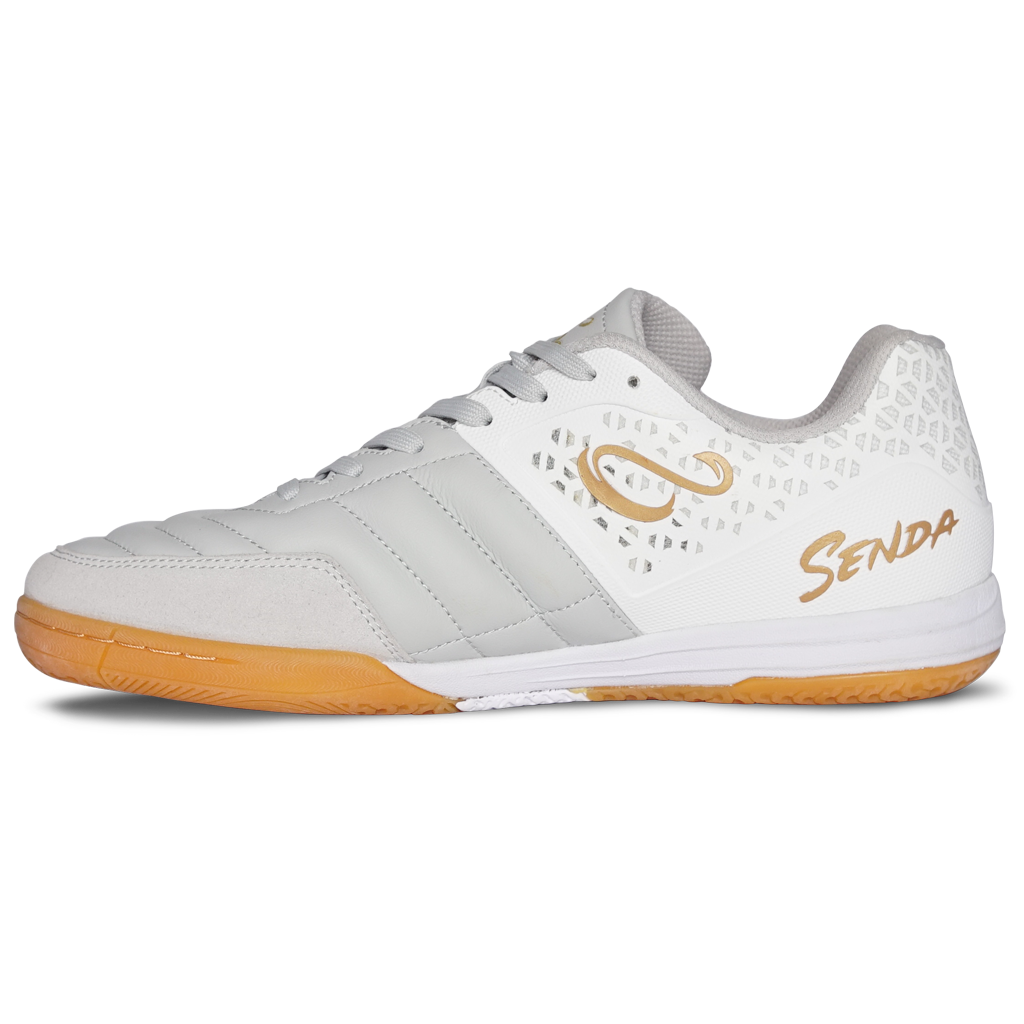 Senda Ushuaia Club 2.0 futsal shoe in white and gold—side view with breathable mesh panel, gold S logo, and quilted synthetic toe box for indoor play.

