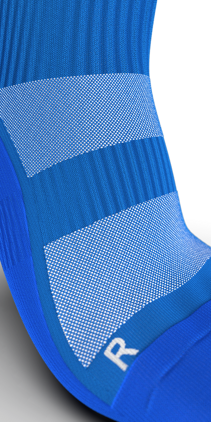 Detailed view of Gravity Pro blue sock with mesh panels and ribbed zones for optimal fit and compression.

