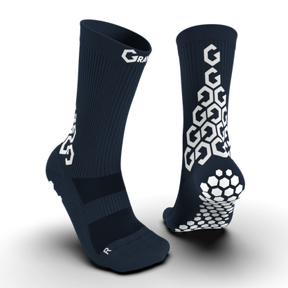 Navy blue Senda Gravity Pro Crew Length Grip Socks showing front and back with hex grip sole and white Gravity branding.

