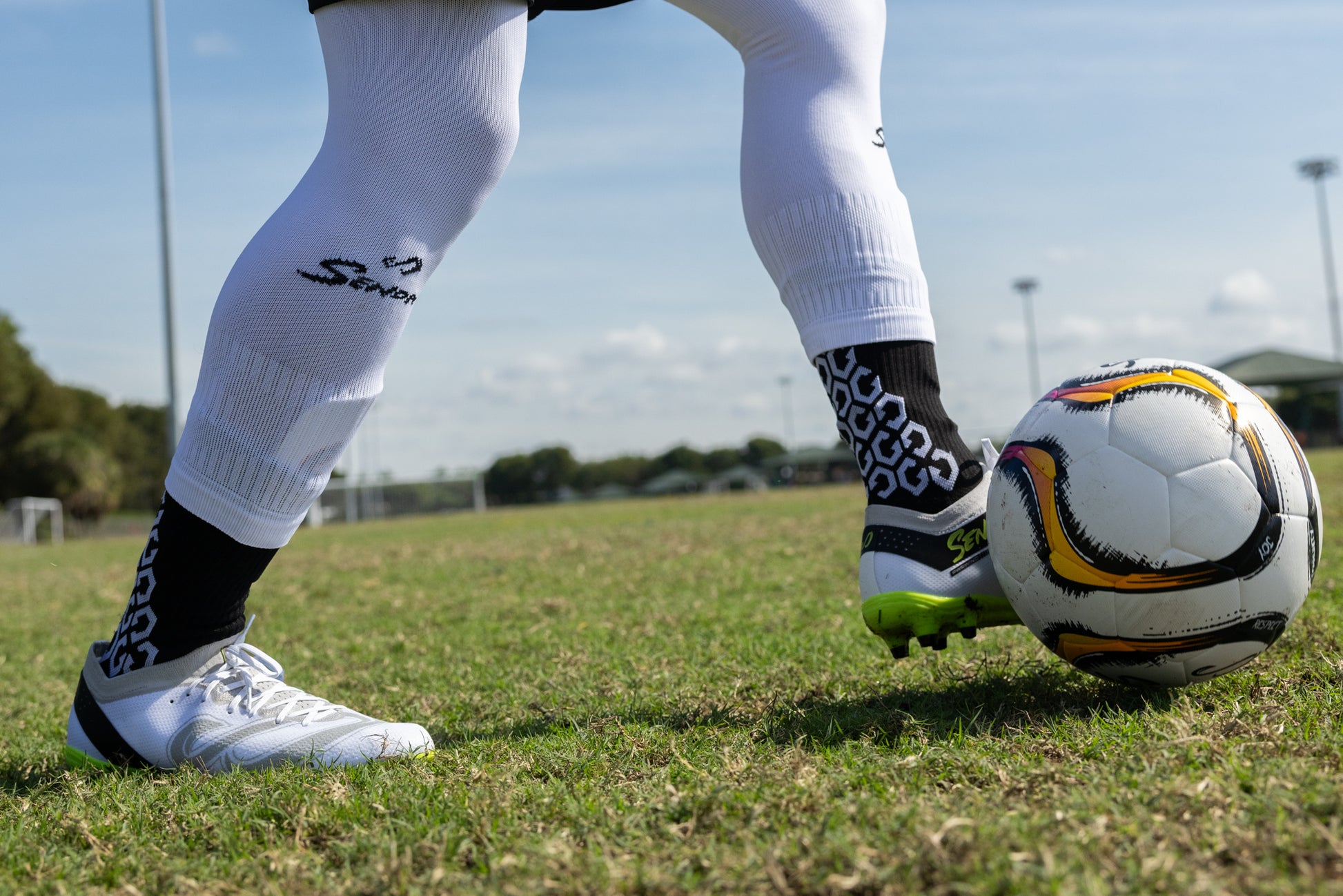 Soccer player in motion wearing Senda Pampa Pro Cleats during a game, showcasing stud grip and athletic positioning.

