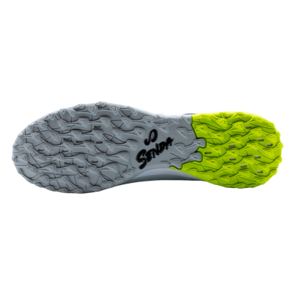 Bottom view of Senda Pampa Pro Turf outsole showing multi-directional stud pattern in lime and gray for maximum control on turf.

