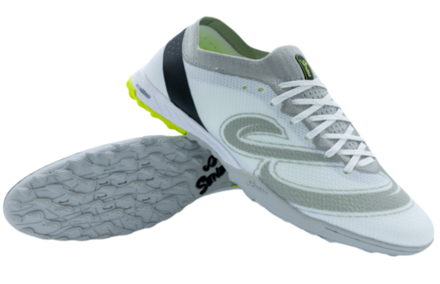 Senda Pampa Pro Turf soccer shoes in white and grey shown from side and sole angle, featuring hybrid-stud outsole and breathable knit upper.

