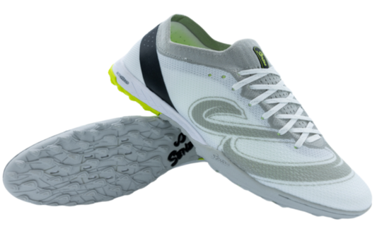 Senda Pampa Pro Turf soccer shoes in white and grey shown from side and sole angle, featuring hybrid-stud outsole and breathable knit upper.

