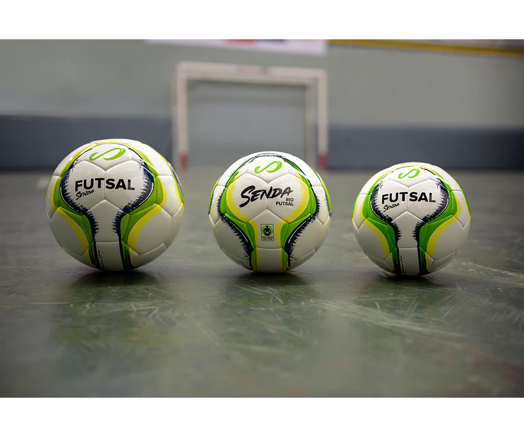 Three Senda Rio Match Futsal balls in green colorway displayed in different sizes on an indoor futsal court.

