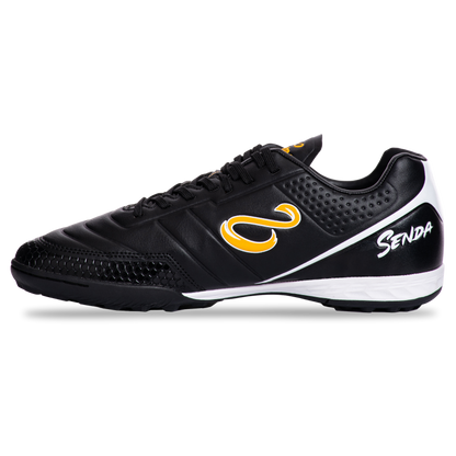 Outer side view of Senda Ushuaia Academy Turf Black shoes highlighting stitched black upper and yellow Senda logo.

