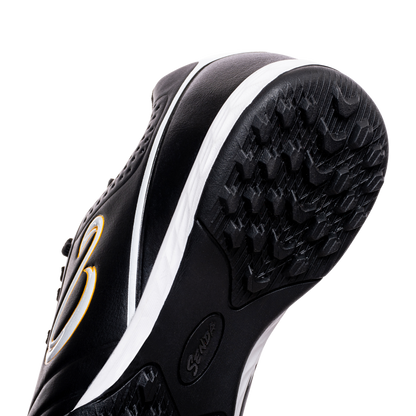 Bottom angled view of Senda Ushuaia Academy Turf Black showing black multi-stud rubber outsole for turf traction.


