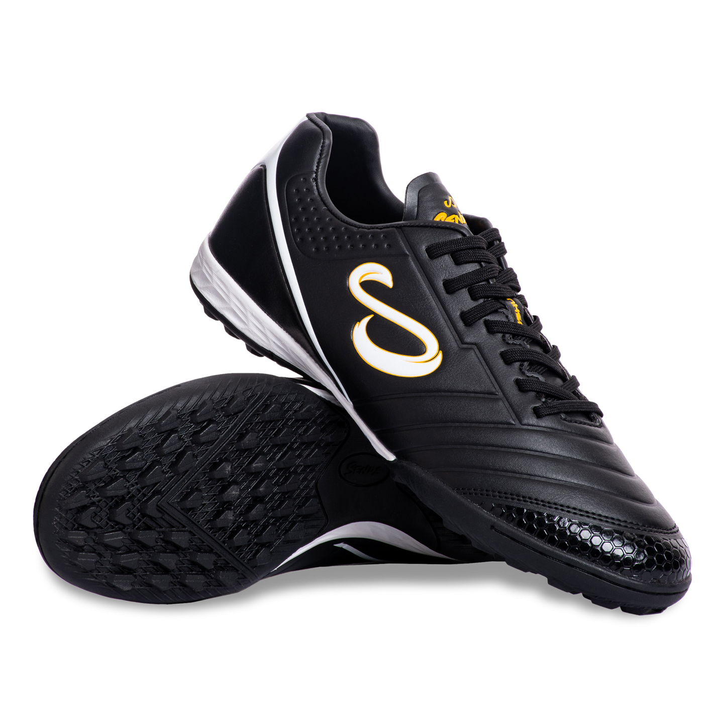 Pair of Senda Ushuaia Academy Turf Black shoes displayed with sole and side view showing grip pattern and bold S logo.

