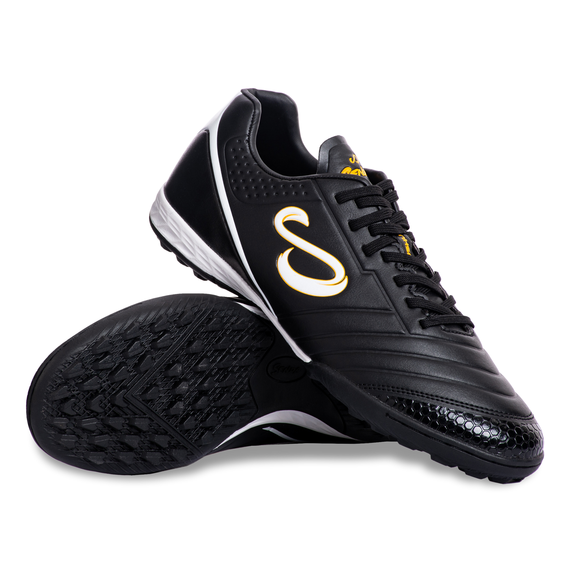 Pair of Senda Ushuaia Academy Turf Black shoes displayed with sole and side view showing grip pattern and bold S logo.

