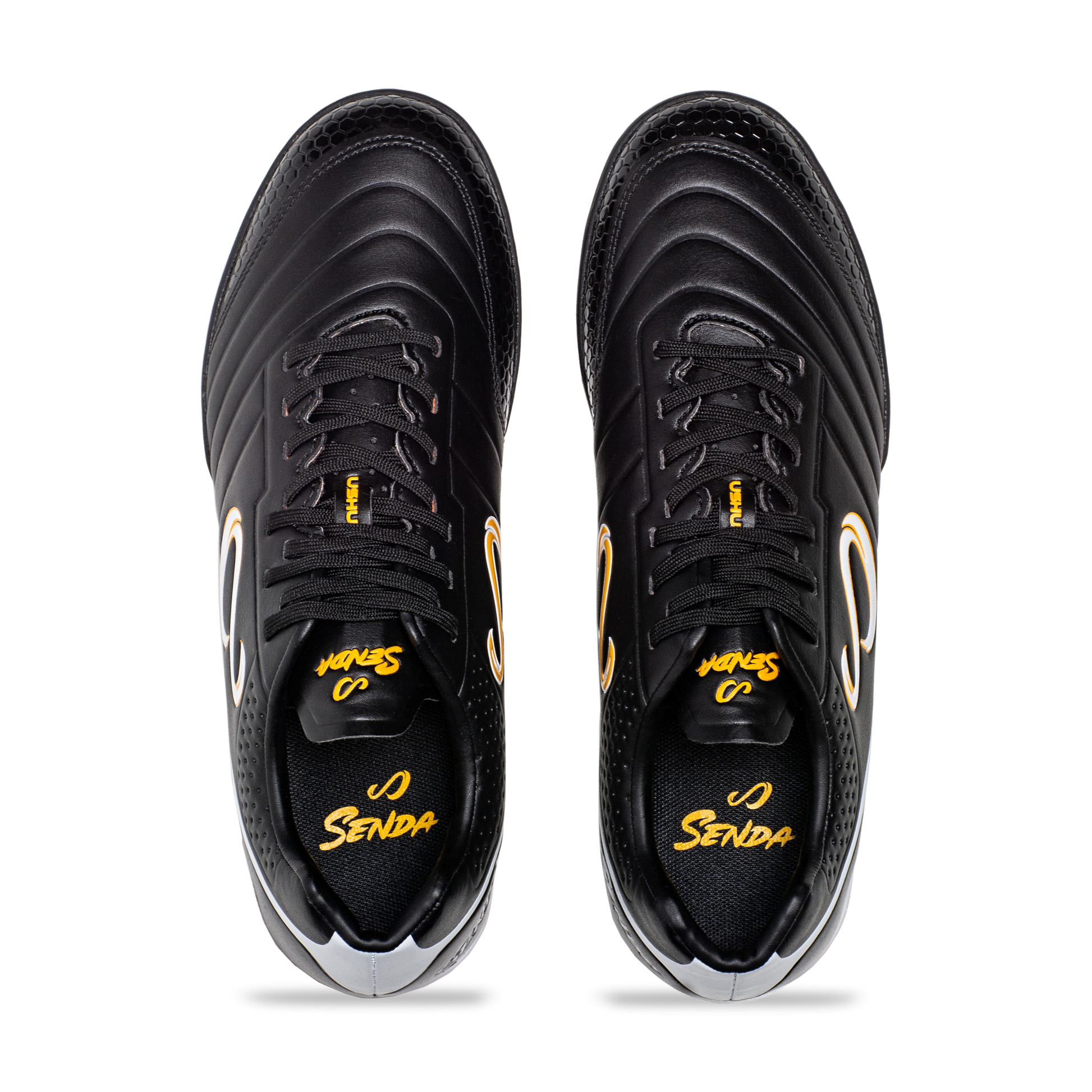 Top view of Senda Ushuaia Academy Turf Black showing lace-up closure, padded collar, and insole branding.

