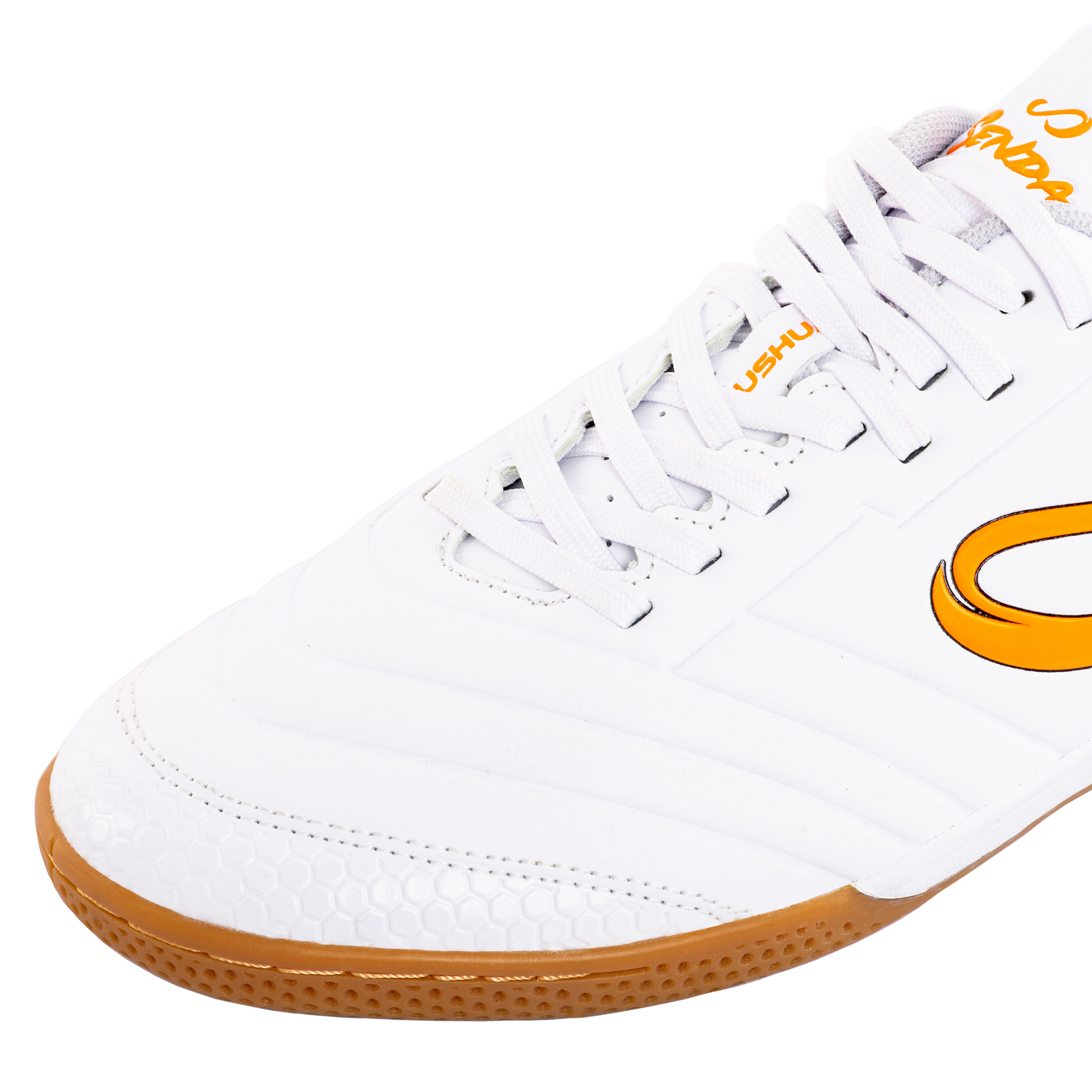 Close-up of Senda Ushuaia Academy White futsal shoe showing detailed stitching, honeycomb toe guard, and lace panel for reinforced fit.

