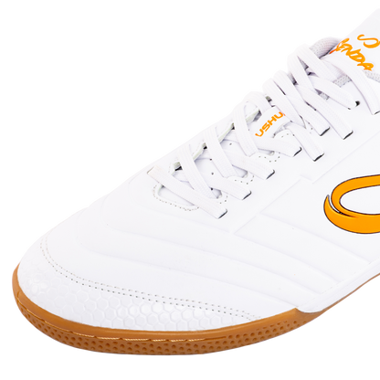 Close-up of Senda Ushuaia Academy White futsal shoe showing detailed stitching, honeycomb toe guard, and lace panel for reinforced fit.


