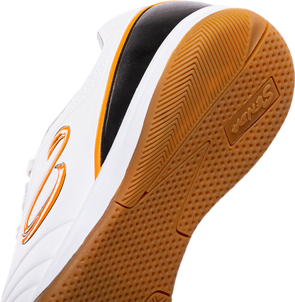 Close-up of the gum rubber outsole on Senda Ushuaia Academy White futsal shoe, showing traction detail and logo branding.


